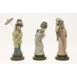 Three Lladro china figures, of Japanese women, one with parasol, tallest 29cm