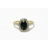 A gold oval cut sapphire and diamond cluster ring, marked 18ct and plat3.14g