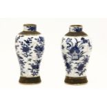 A pair of small Chinese crackle glaze vases, of baluster form, each decorated in blue with