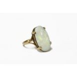 A single stone oval cabochon opal ring, claw set to a split shoulders, on a plain polished shank,