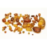 A collection of graduating amber beads and drop pendants, some with insectstotal weight including