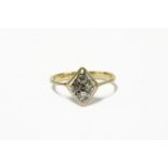 An Art Deco gold four stone diamond lozenge shaped cluster ring, marked 18ct