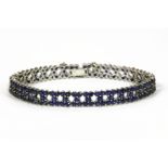 A white gold three row sapphire line bracelet, tested as approximately 9ct white gold18.14g