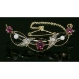 A late Victorian ruby, diamond and cultured pearl open crescent brooch, c.1890, of ribbon form. A