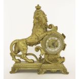 A French gilt mantel clock, the dial with enamelled numerals, mounted with a lion to the side,33.5cm