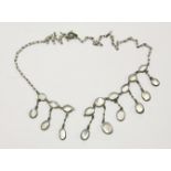 A silver Edwardian moonstone necklace with moonstone fringe (one link missing)7.04g