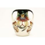 A large modern Moorcroft 'Anna Lily' pattern twin handled vase, 25cm high