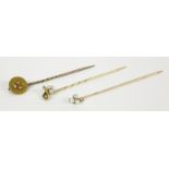 A gold split pearl shamrock stick pin marked 18ct, a split pearl stick pin in the form of a