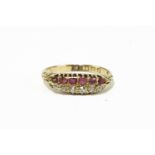 An 18ct gold two row diamond and ruby six stone ring, dated 1902