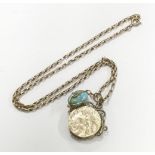 A gold belcher chain, marked 9k (with replacement clasp) with a gold wire caged turquoise coloured