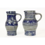 Two German Westerwald type salt glazed stoneware jugs, 23.5cm and 24cm high