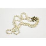 A two row graduated cultured pearl necklace with gold cultured pearl and stained howlite clasp,