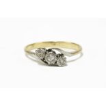 A gold three stone diamond crossover ring, marked 18ct2.80g