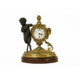 A French table clock, the enamelled dial with floral garlands, in a gilt bronze urn shaped case, a