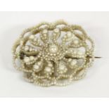 A Victorian seed pearl and mother of pearl floral brooch