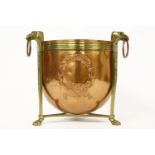 A copper and brass mounted bucket, with embossed laurel rings, the stand with eagle head