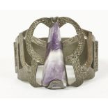 A 1974 triangular cabochon amethyst bangle with pierced top section, worked bark and scale