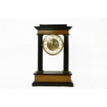 A 19th century French ebonised portico clock, with an enamel dial, no pendulum, 48cm high