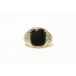 A gentleman's cushion shaped signet ring, with inset triangular panels to the shoulders4.40g