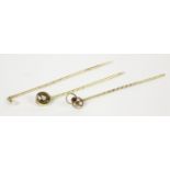 A gold single seed pearl stick pin marked 15ct, a late Edwardian 15ct gold garnet and seed pearl