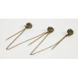 Three assorted gold Jersey stick pins of peacocks, set with emeralds and seed pearls3.79g