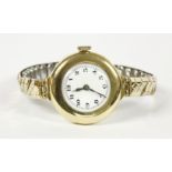 A ladies 18ct gold mechanical watch, with white enamel dial and Arabic numerals, with later