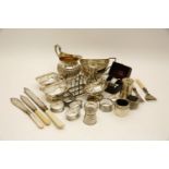 A miscellaneous group of silver, comprising: a silver milk jug, a sugar bowl, a toast rack, three