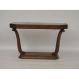 A walnut hall table, raised on scrolled supports on a plinth, 131cm wide, 57.5cm deep, 83cm high
