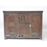 A 17th century Dutch panelled door cupboard, (rodent holes), 168cm long x 125cm high