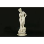 An early 20th century carved figure of a female on a stand