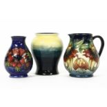 Three Moorcroft items: a vase, in blue and yellow. 14.5cm high, a modern jug, 14.5cm high, and a