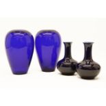 A pair of blue glass vases together with a pair of blue glazed porcelain vases, possibly Chinese.