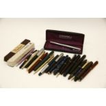 A collection of old pens, including Parker and Conway Stewart examples