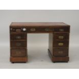 A mahogany desk, with brass bound details and recessed handles, 119.5cm wide