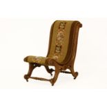 A Victorian walnut slipper chair, with tapestry upholstery