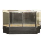 An Art Deco polished steel and ebonised counter,the glass top with silvered mounts over an