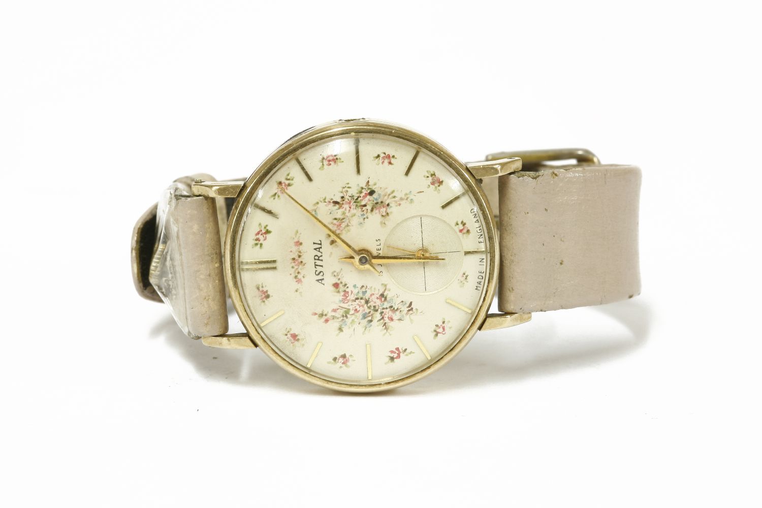 A gentlemen's 9ct gold Astral mechanical strap watch, cream dial with floral print and baton makers,