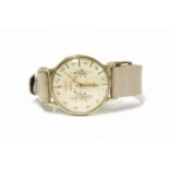 A gentlemen's 9ct gold Astral mechanical strap watch, cream dial with floral print and baton makers,