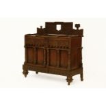 An unusual Continental carved oak cabinet, 19th century, with a carved raised back, over two