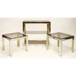 A chrome and brassed metal pier table, with a smoked glass top, shelf and under tier, 76cm wide x