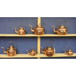 Seven graduated copper and brass kettles, longest 29cm high