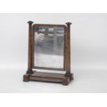 A William IV mahogany toilet mirror, the large adjustable rectangular plate on turned uprights