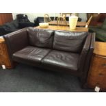 A Danish two seater dark brown settee,158cm wide