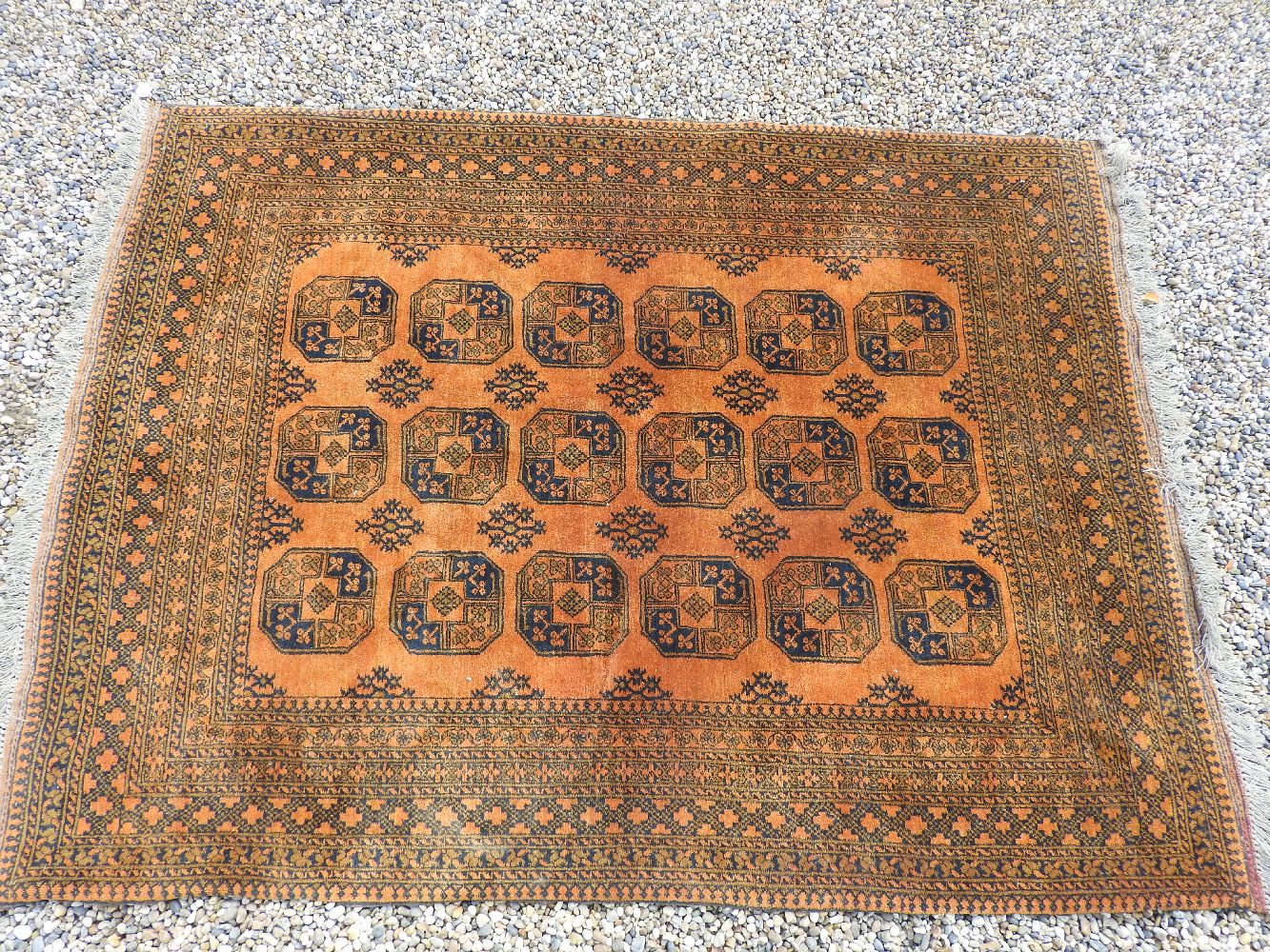 An Afghan rust ground rug, 265 x 202cm