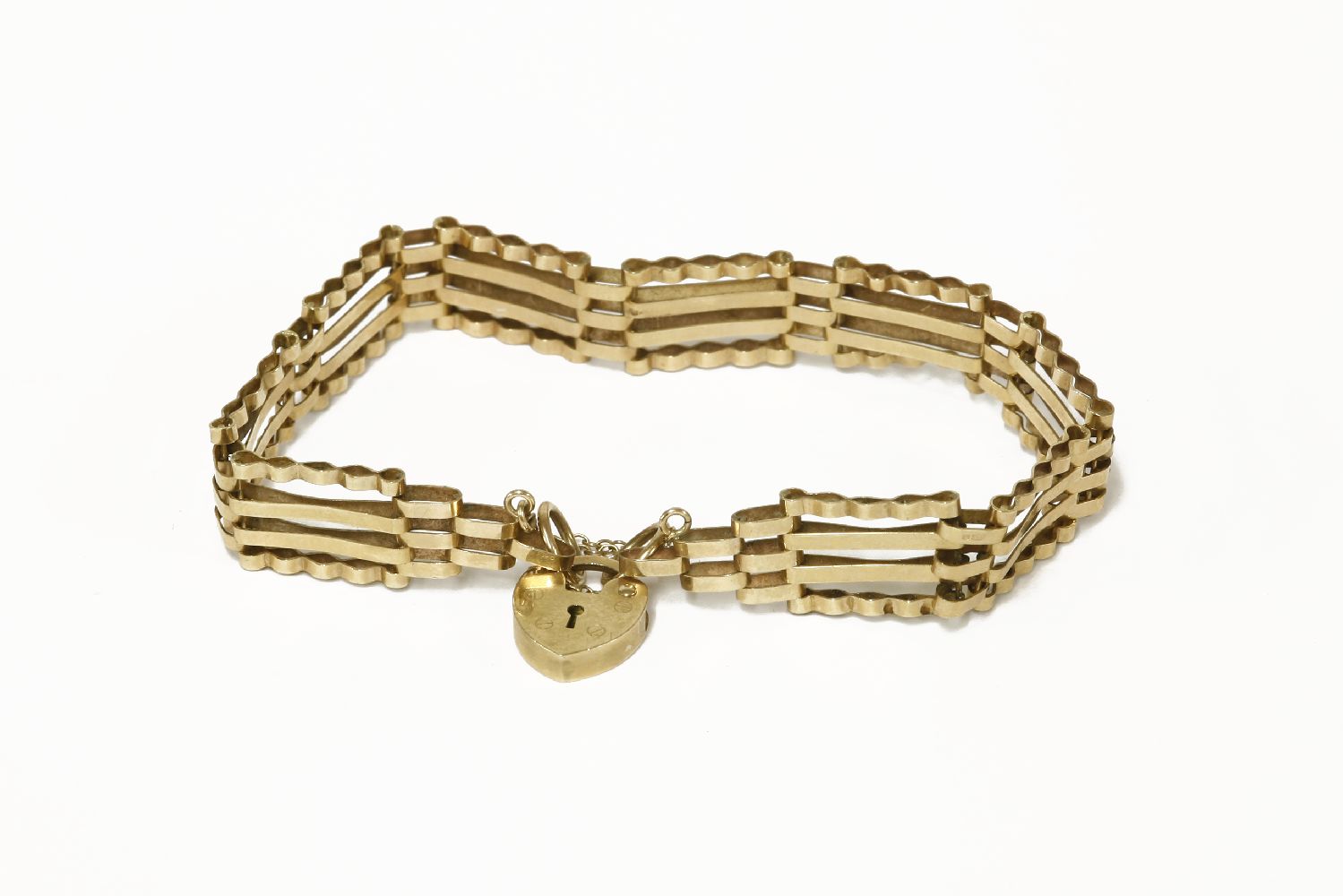 A gold four row gate link bracelet, with two pairs of straight links between two crimpled links,