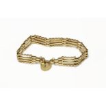 A gold four row gate link bracelet, with two pairs of straight links between two crimpled links,