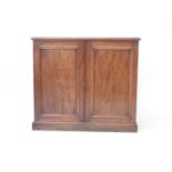 A Victorian mahogany linen cupboard, the moulded rectangular top, over panel doors, opening to
