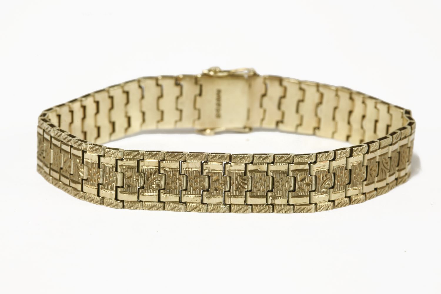 A gold flat link bracelet, each link engraved with decoration, marked 9ct14.65g