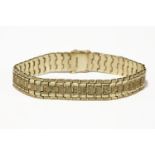 A gold flat link bracelet, each link engraved with decoration, marked 9ct14.65g