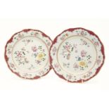 A pair of Chinese famille rose plates, decorated with flowers